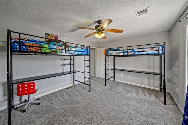 carpeted bedroom featuring ceiling fan and a textured ceiling