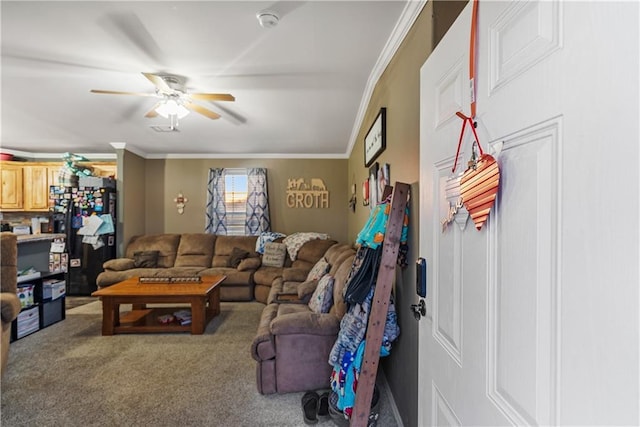 carpeted living room featuring ornamental molding and ceiling fan