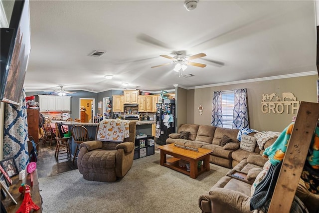 living room with ornamental molding, vaulted ceiling, and ceiling fan