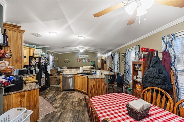 dining room with sink, dark wood-type flooring, ornamental molding, and ceiling fan