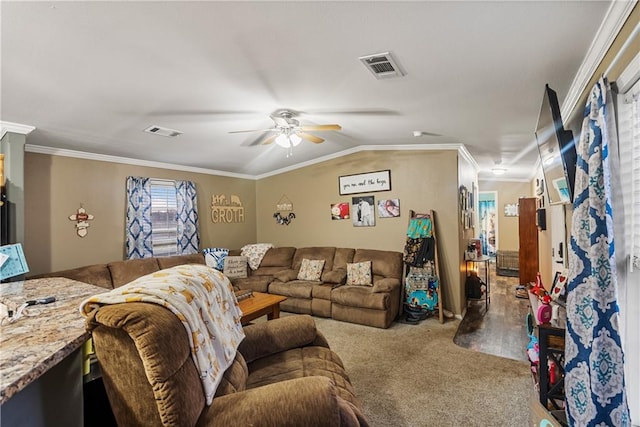 living room with ornamental molding, vaulted ceiling, carpet flooring, and ceiling fan