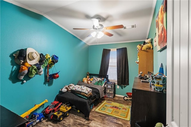 bedroom featuring hardwood / wood-style floors, vaulted ceiling, ornamental molding, and ceiling fan