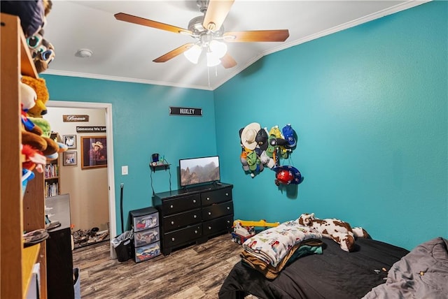 bedroom with lofted ceiling, crown molding, wood-type flooring, and ceiling fan