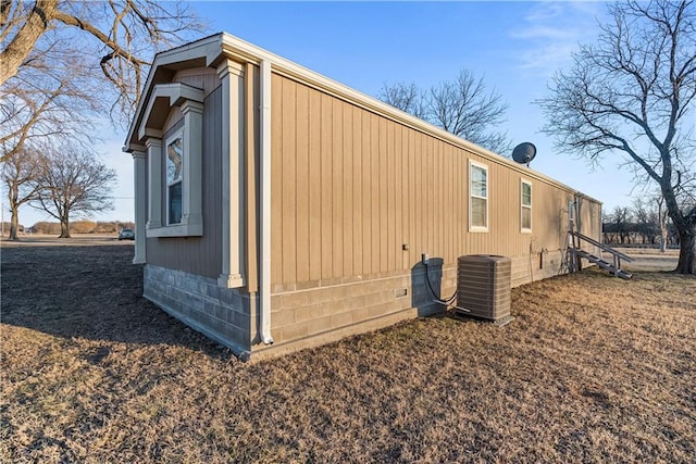 view of side of property featuring central air condition unit