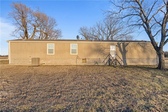 rear view of house featuring central AC unit