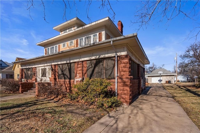 view of home's exterior featuring a garage and an outbuilding