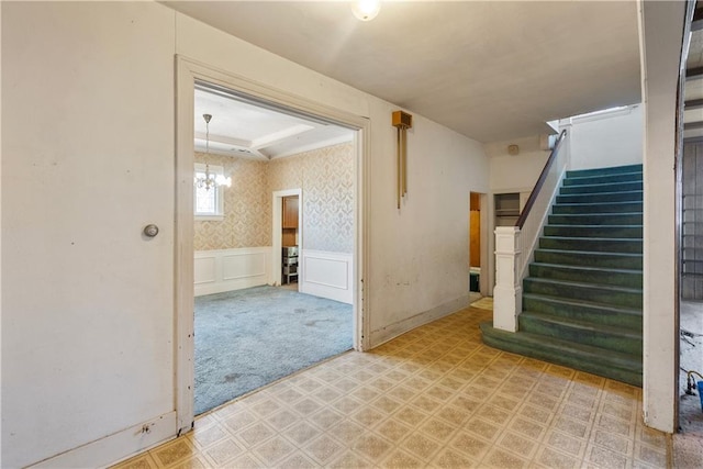 interior space featuring carpet flooring and a notable chandelier