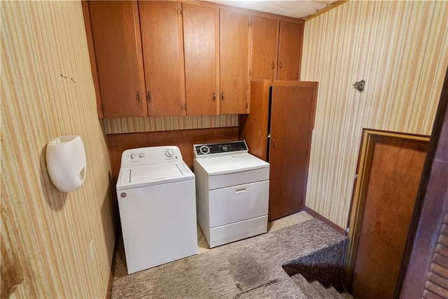 washroom featuring light colored carpet, cabinets, and washing machine and dryer