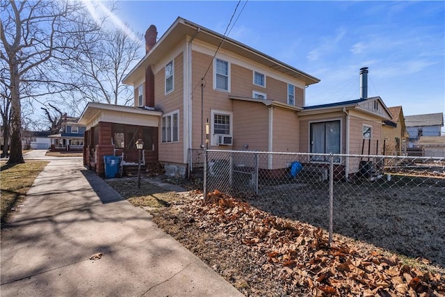 view of side of home featuring a sunroom and cooling unit