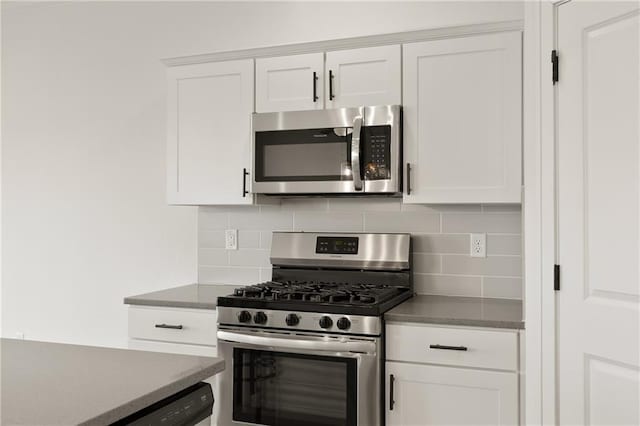 kitchen featuring backsplash, appliances with stainless steel finishes, and white cabinets