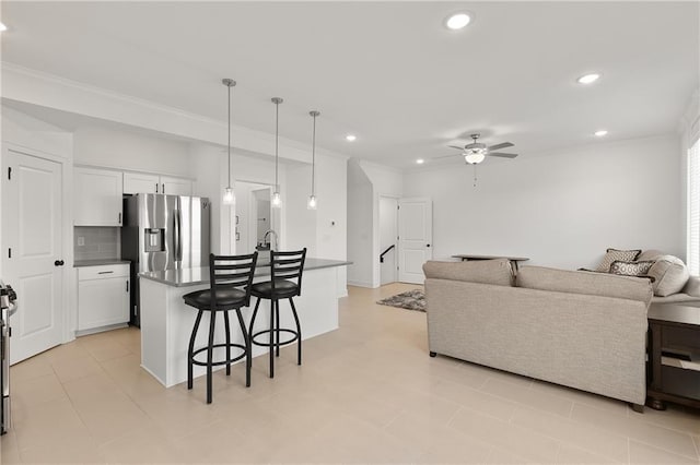 living room featuring crown molding and ceiling fan