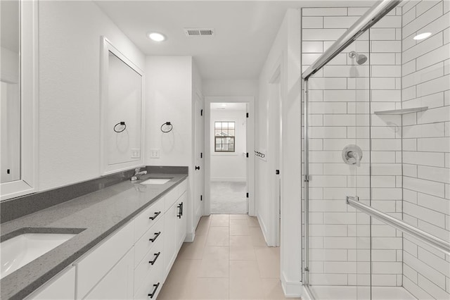 bathroom with vanity, tile patterned floors, and walk in shower