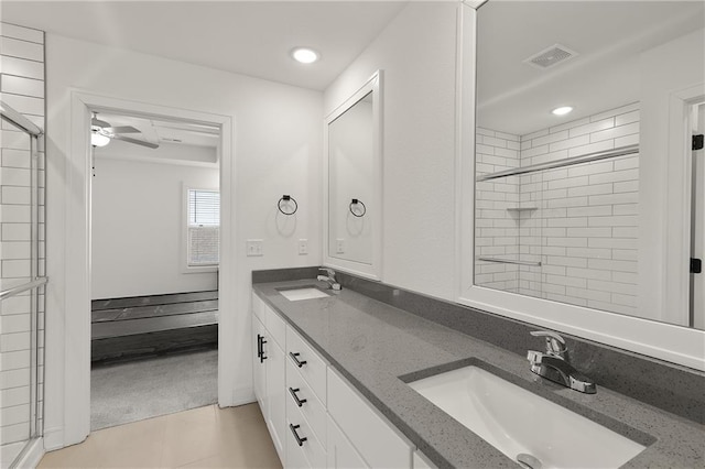 bathroom featuring a shower with door, vanity, tile patterned flooring, and ceiling fan