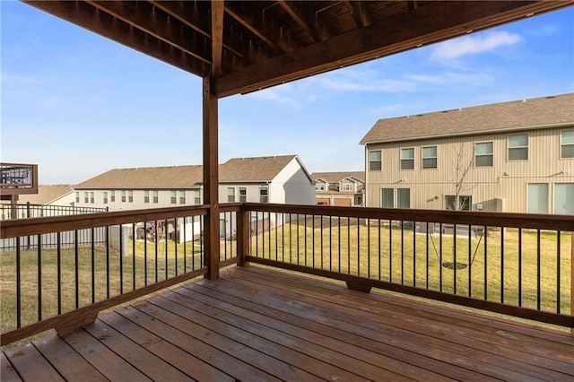 wooden terrace featuring a lawn