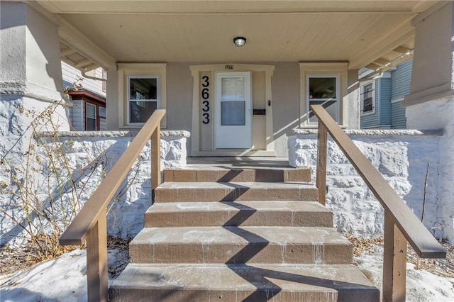 view of snow covered property entrance