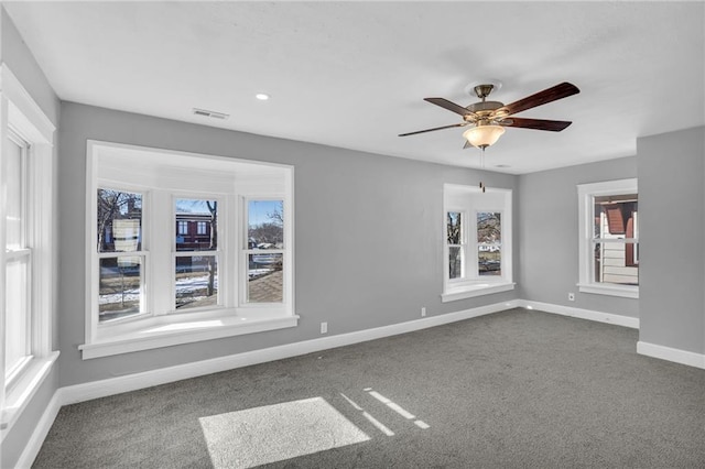 empty room with ceiling fan and carpet