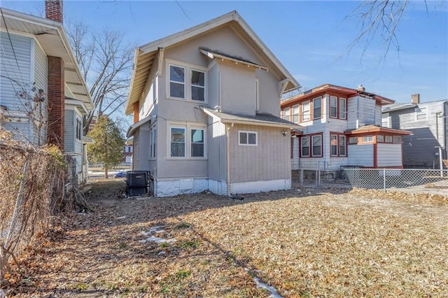 rear view of property with central AC unit