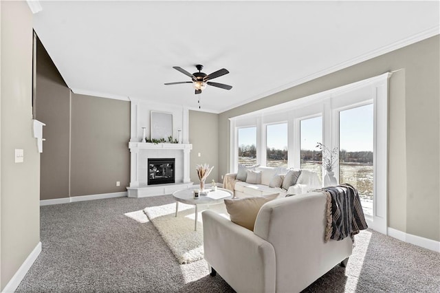 living room featuring a large fireplace, a healthy amount of sunlight, carpet, and ornamental molding