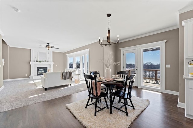 dining area featuring a wealth of natural light, a fireplace, and ornamental molding