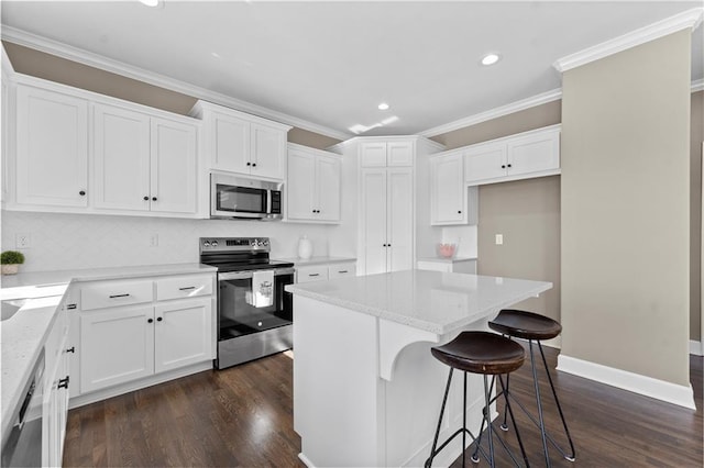 kitchen featuring white cabinetry, stainless steel appliances, and a kitchen island