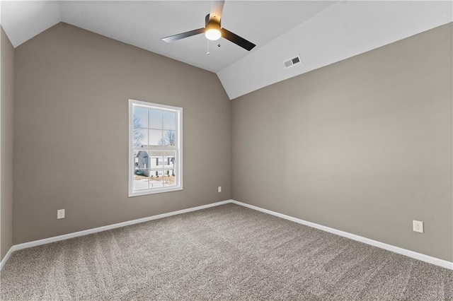 carpeted empty room featuring vaulted ceiling and ceiling fan