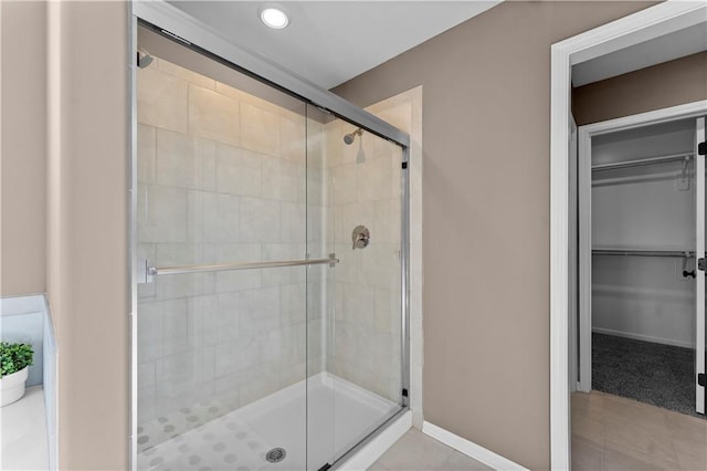 bathroom featuring tile patterned flooring and a shower with door