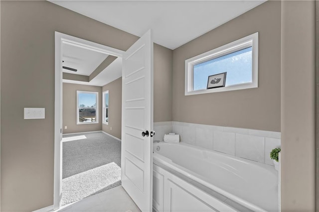 bathroom featuring tile patterned floors and a tub