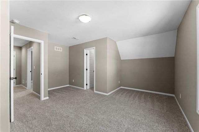 bonus room featuring light colored carpet and lofted ceiling