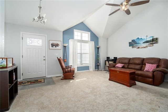 carpeted living room with vaulted ceiling and ceiling fan with notable chandelier