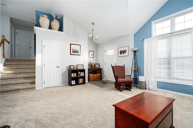 sitting room with light colored carpet, a notable chandelier, and high vaulted ceiling