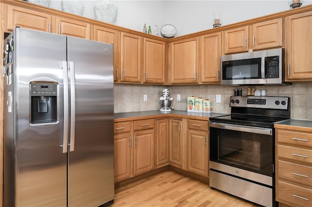 kitchen featuring backsplash, light hardwood / wood-style flooring, and appliances with stainless steel finishes