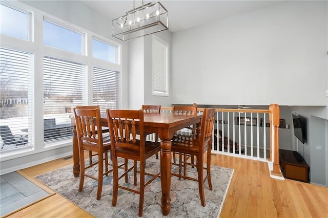 dining space with a chandelier and light hardwood / wood-style floors