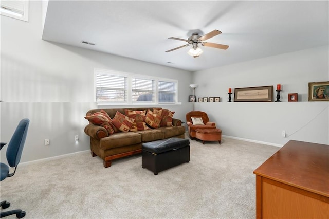 carpeted living room with ceiling fan