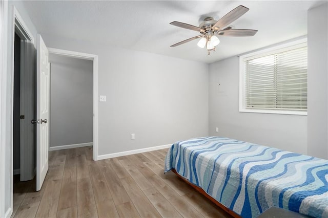 bedroom with light wood-type flooring and ceiling fan