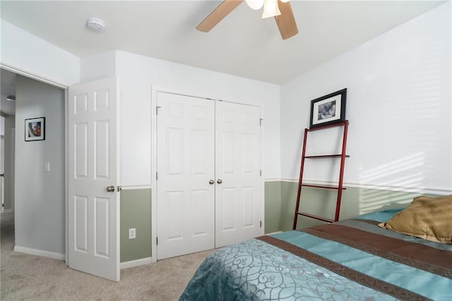 bedroom featuring light carpet, a closet, and ceiling fan