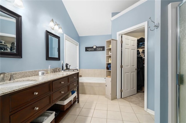 bathroom featuring tile patterned flooring, vanity, lofted ceiling, and plus walk in shower