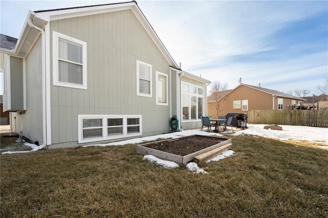 rear view of property featuring a lawn