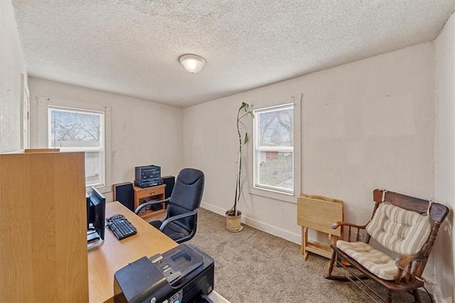 carpeted home office with a textured ceiling