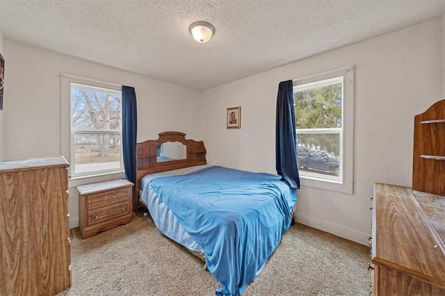 bedroom with light carpet and a textured ceiling