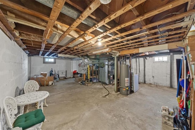 basement featuring heating unit, washer / clothes dryer, and gas water heater