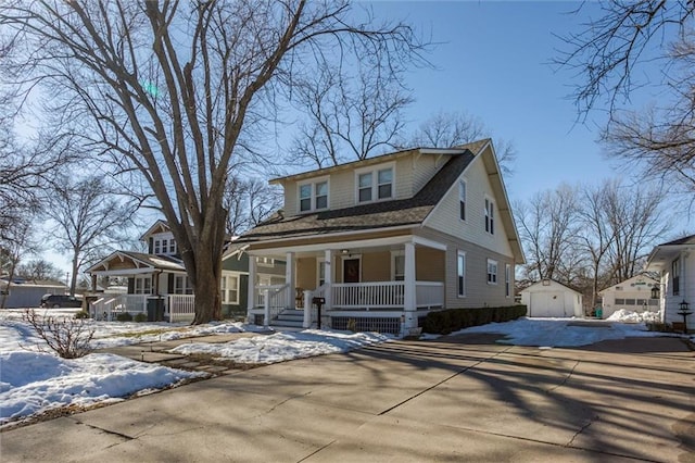 view of front of house featuring a porch and a storage shed