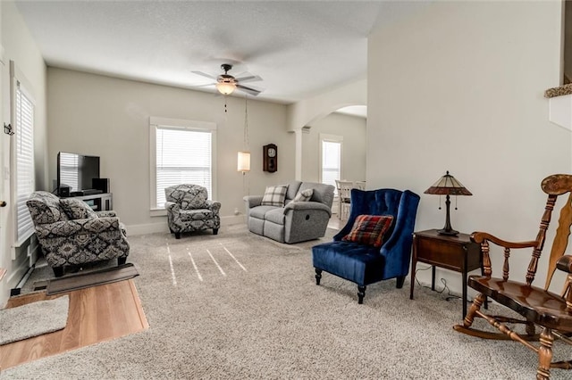 living room featuring ceiling fan, a healthy amount of sunlight, and carpet