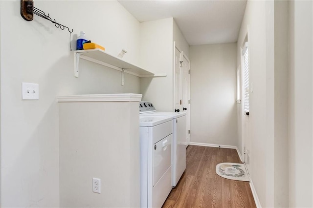 laundry room featuring hardwood / wood-style flooring and washer and clothes dryer