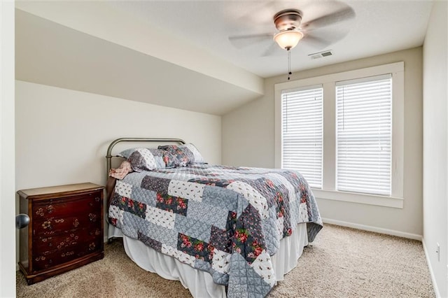 carpeted bedroom featuring multiple windows, vaulted ceiling, and ceiling fan