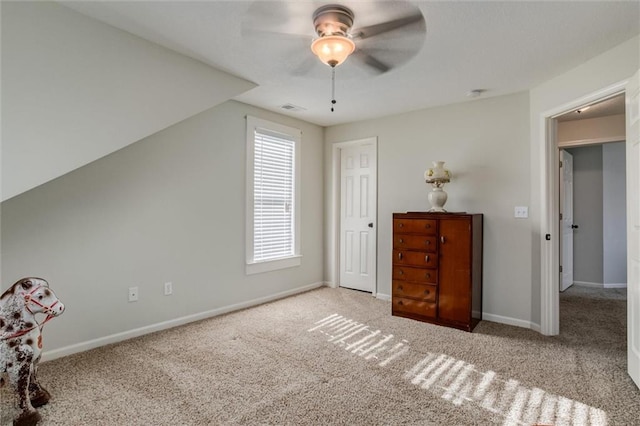 interior space featuring lofted ceiling, light colored carpet, and ceiling fan