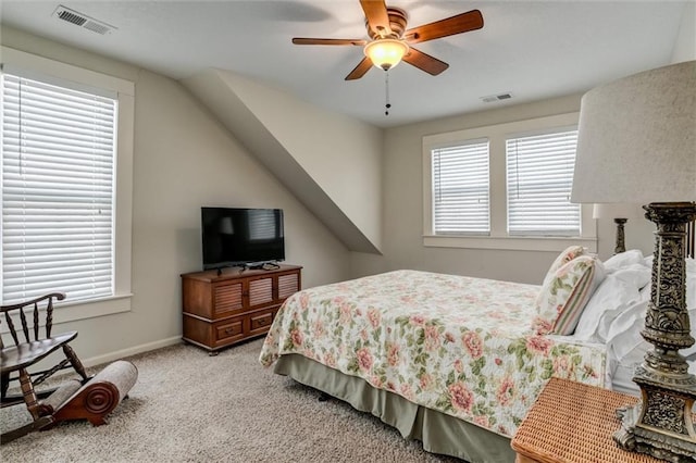 carpeted bedroom with multiple windows and ceiling fan