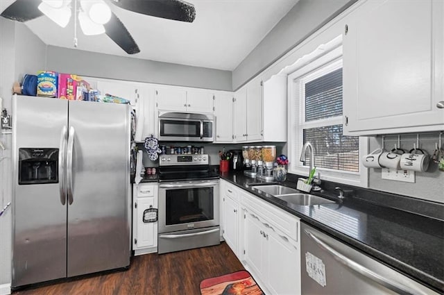 kitchen with sink, dark wood-type flooring, ceiling fan, white cabinetry, and stainless steel appliances