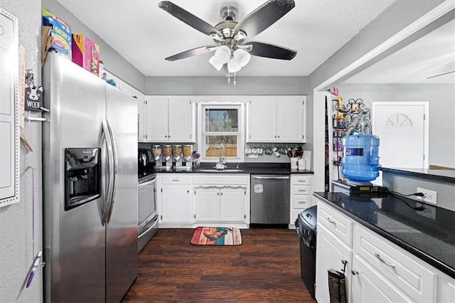 kitchen with backsplash, white cabinets, ceiling fan, stainless steel appliances, and dark wood-type flooring