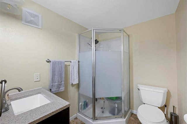 bathroom with walk in shower, vanity, and toilet