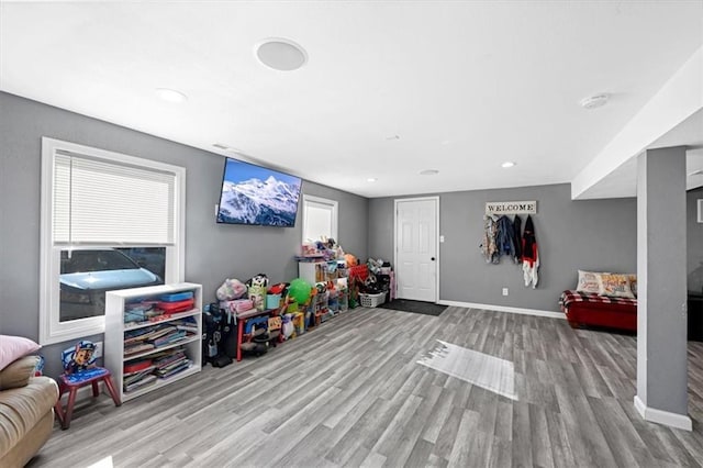 rec room with light hardwood / wood-style flooring